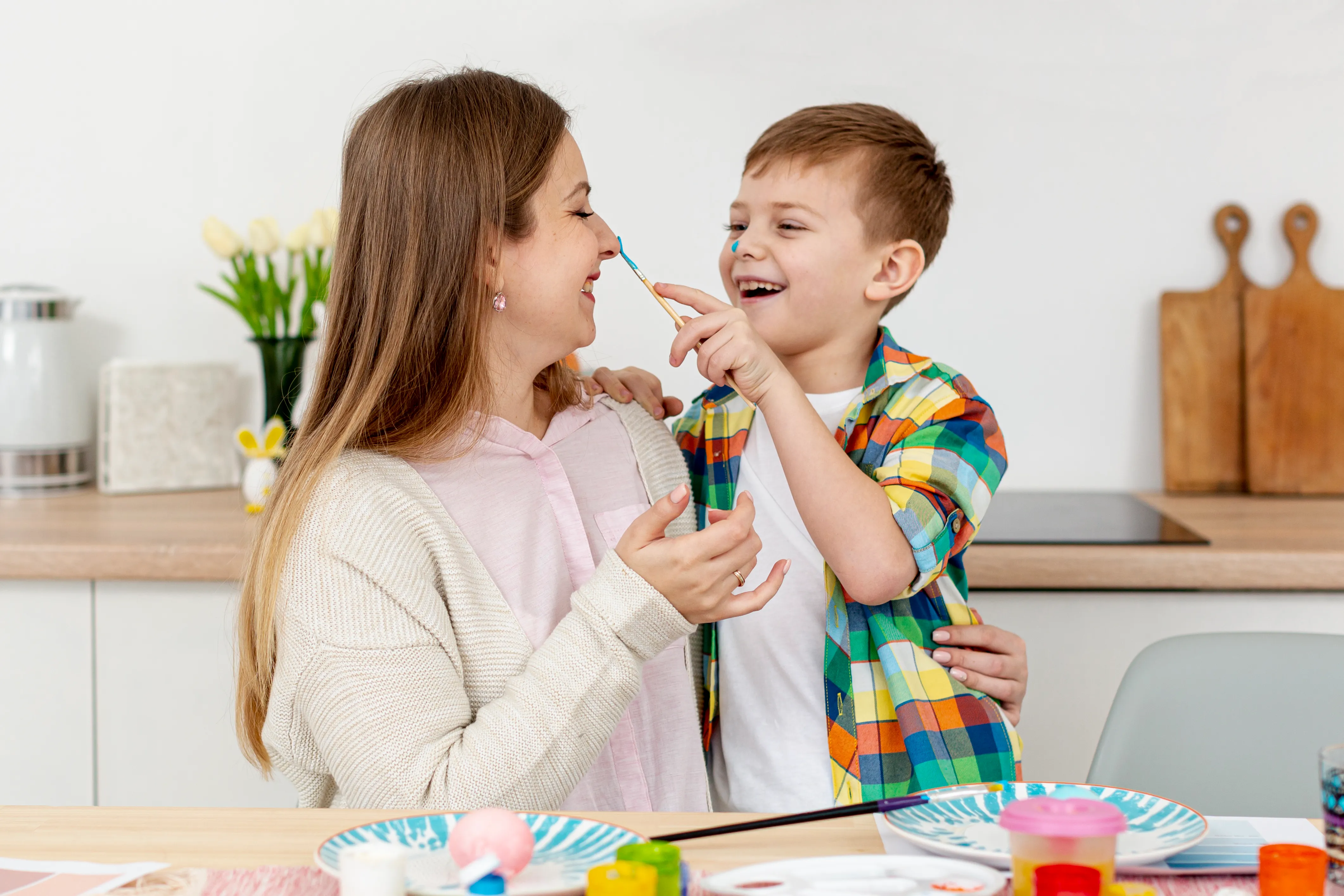 Mother and son engaging in joyful developmental play and communication
